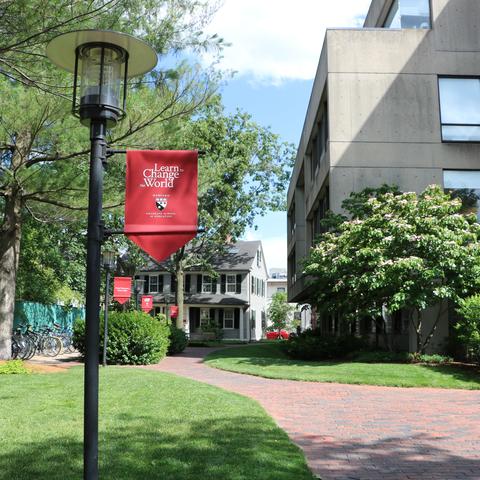 A flag on campus that reads "learn to change the world"
