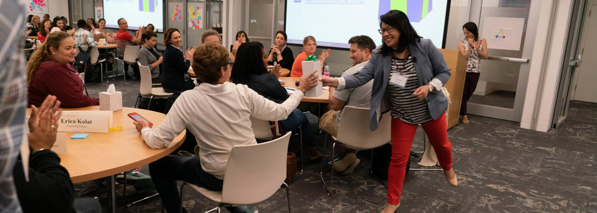Faculty member passes surprise to a participant during a Data Wise institute.
